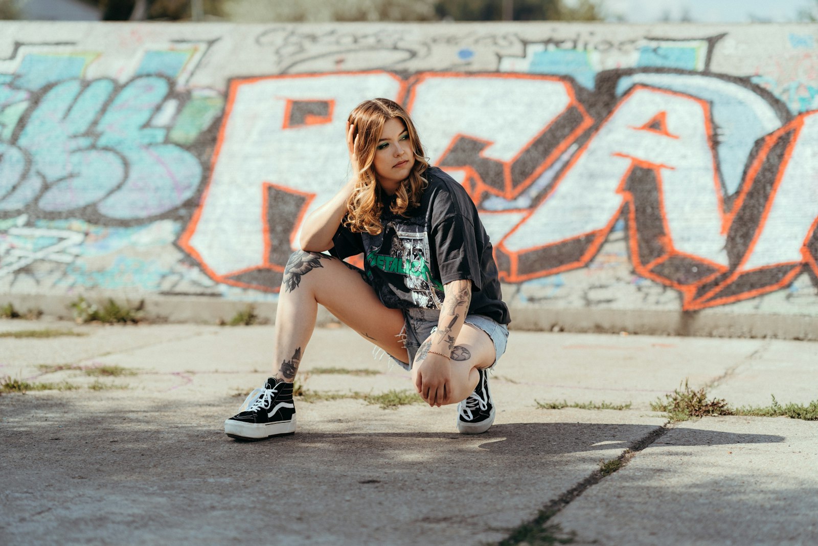 a person squatting on the sidewalk