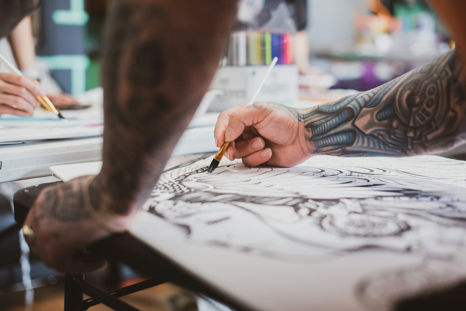 Inside Cleopatra Ink Seattle tattoo studio with artists and clients