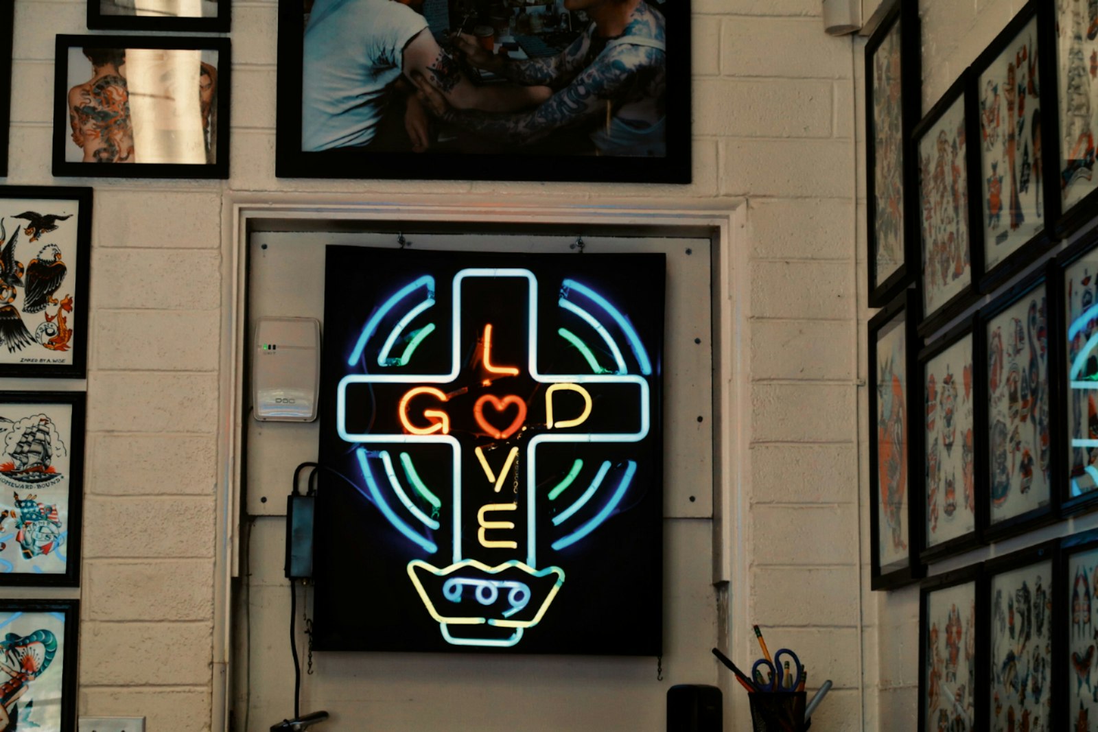 a cross with a heart on it is lit up in the corner of a room