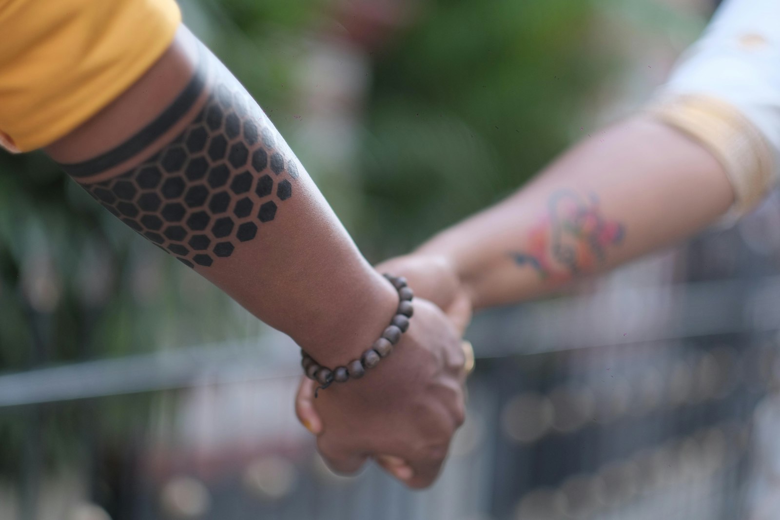 A close up of two people holding hands