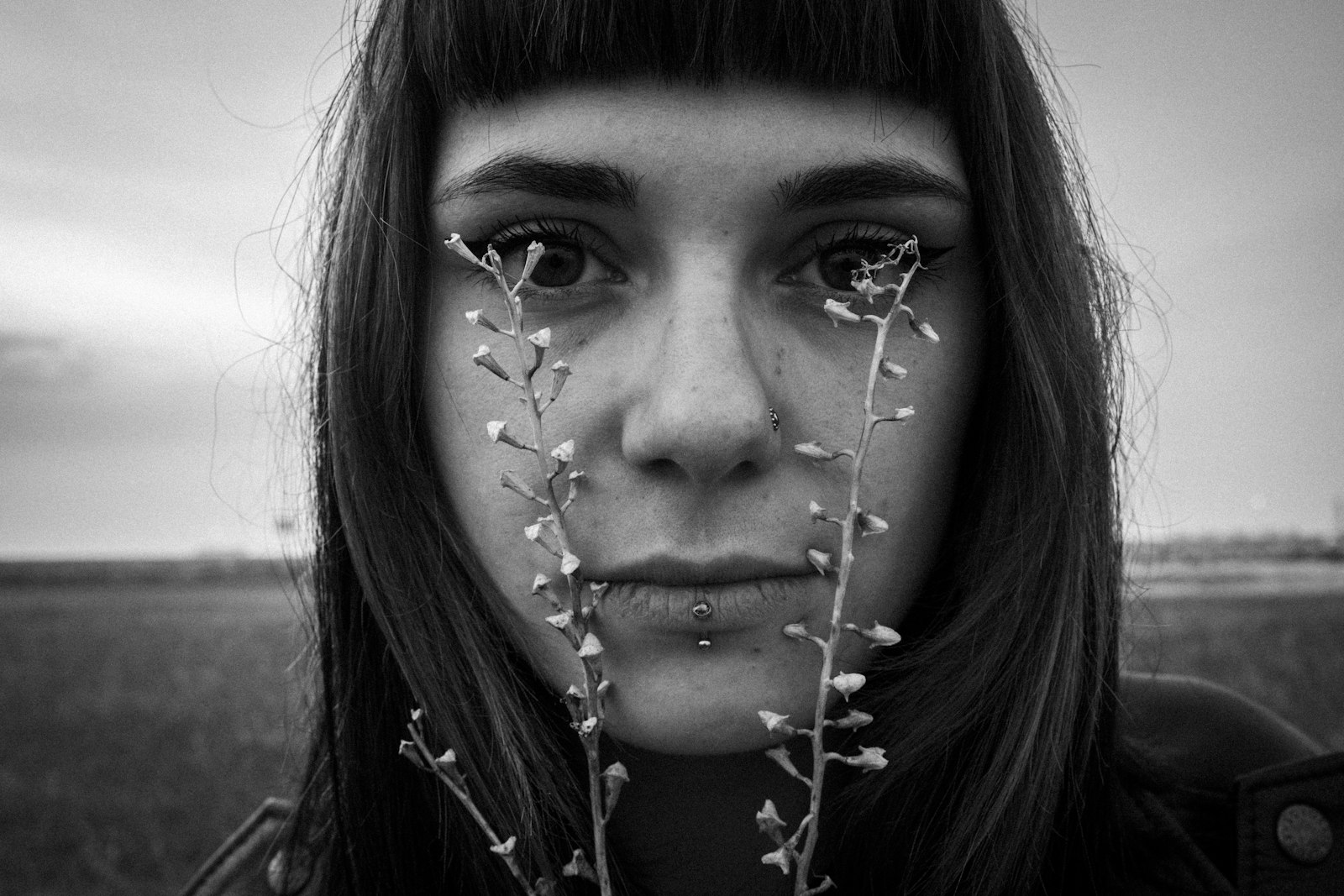 Woman with delicate flowers obscuring her eyes