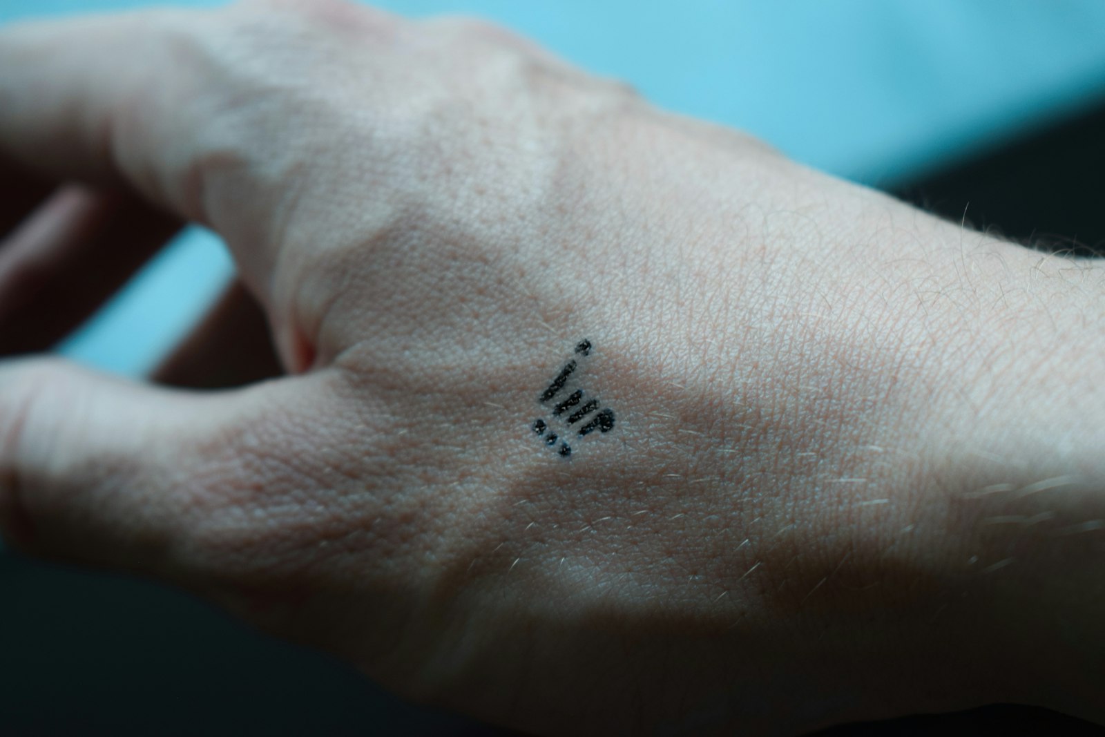black tattoo on persons hand