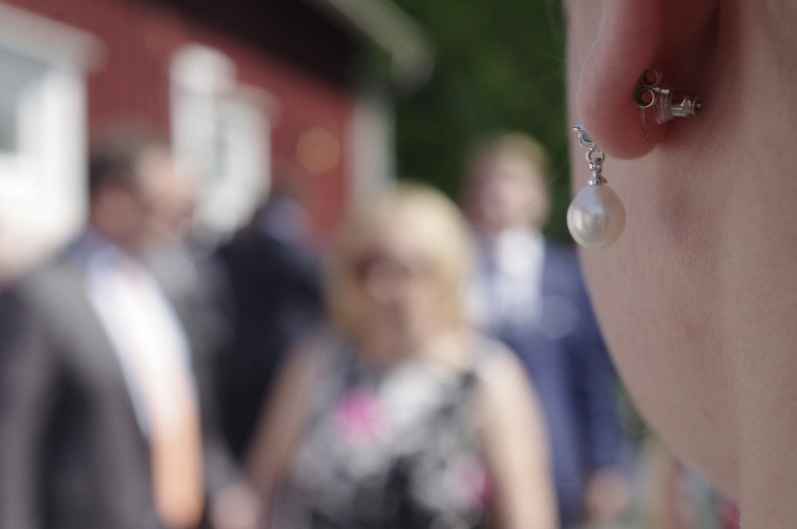 a close up of a person wearing a pair of earrings