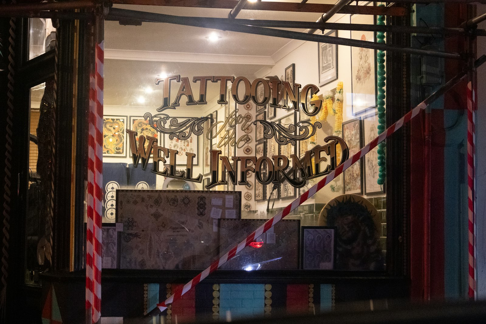 Tattooing well informed sign in shop window