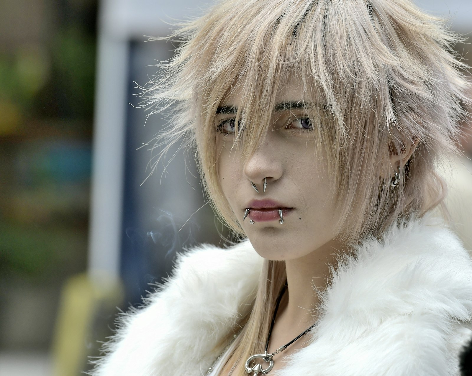 Young woman with blonde hair and piercings.