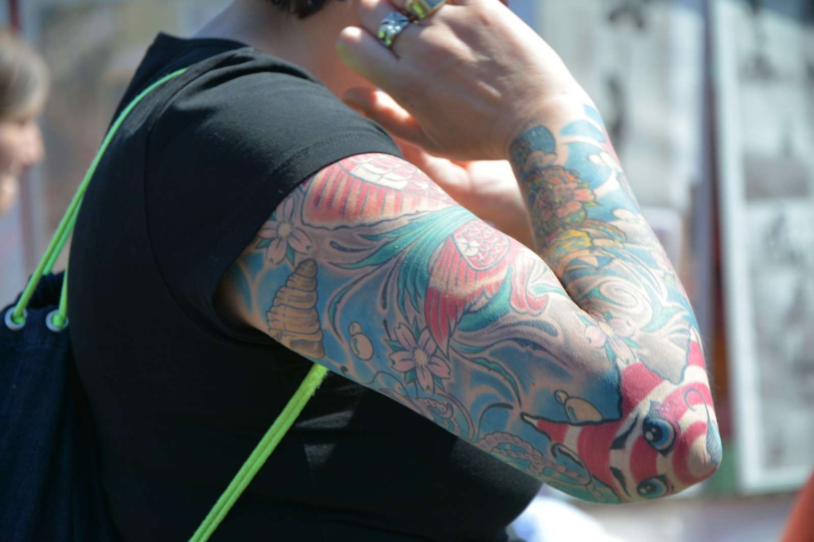 person with purple and red floral arm tattoo