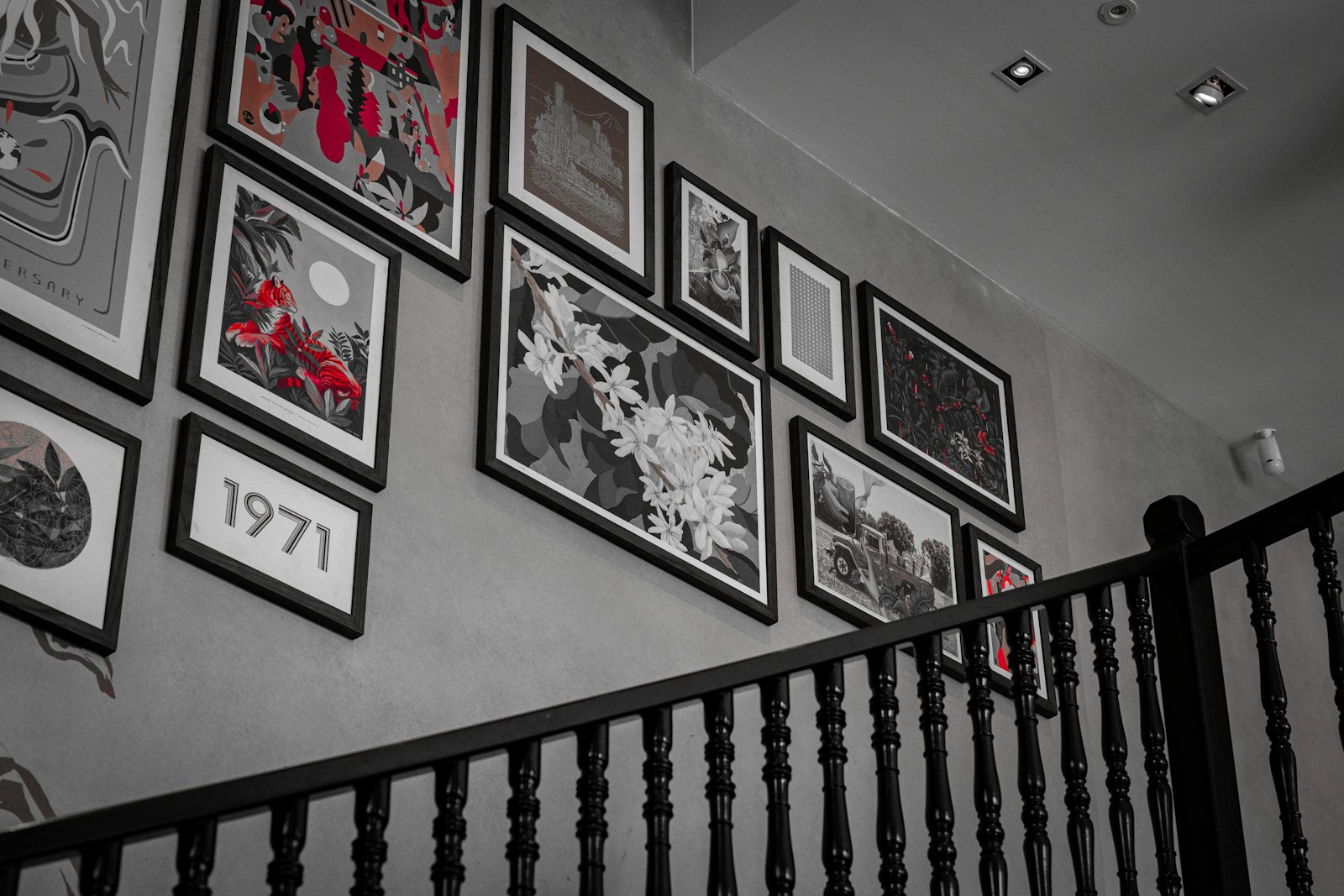 Pictures are displayed in a gallery on a wall.