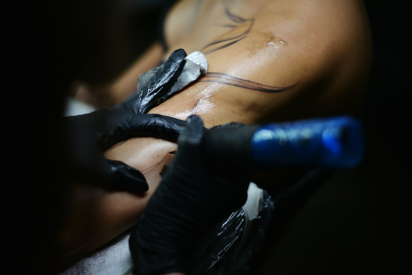 Interior of Cleopatra Ink Seattle tattoo studio with artists and clients