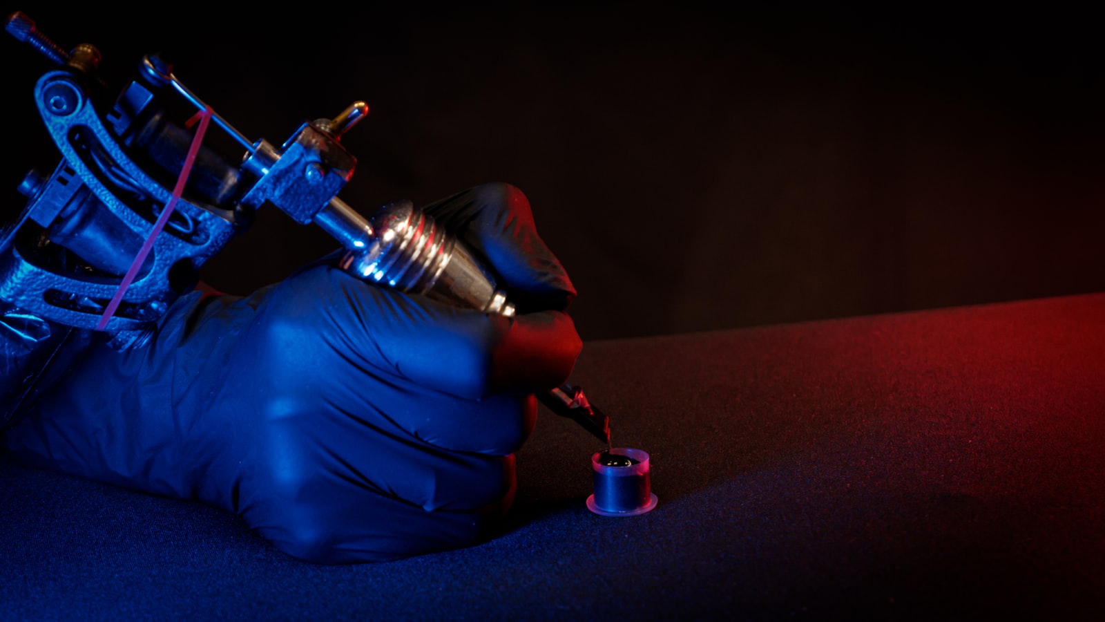 Hand with tattoo machine creating art