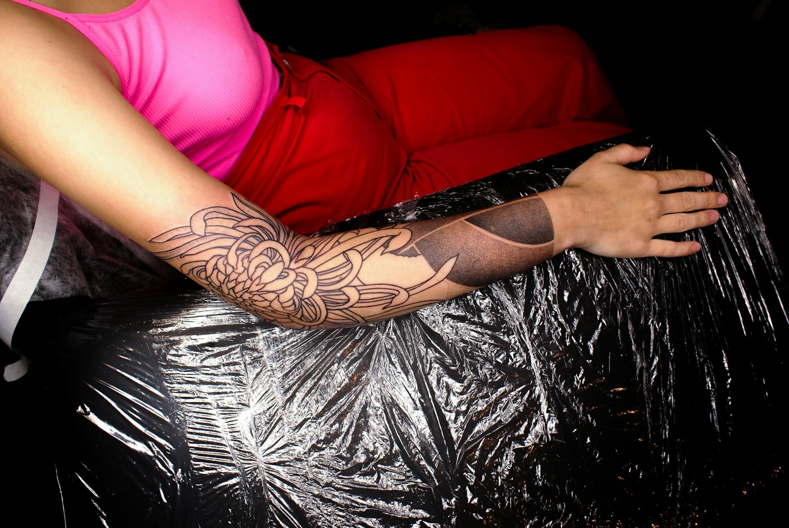 a woman lying on a red couch