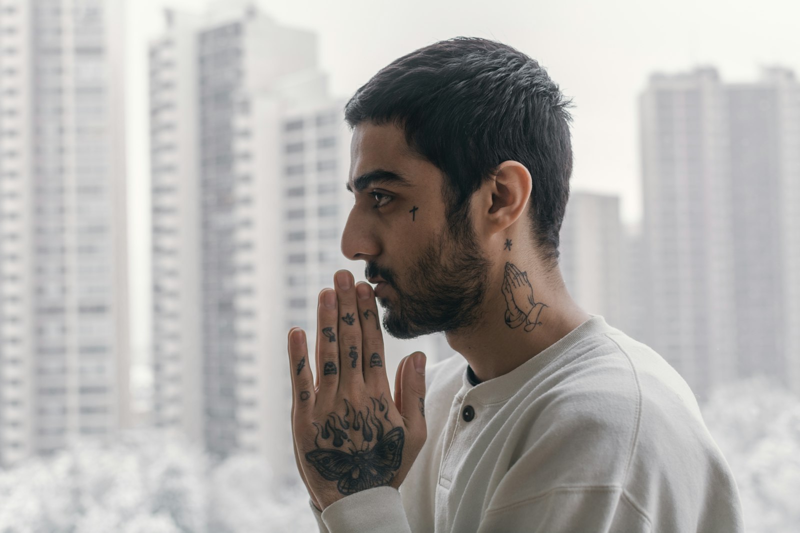 a man with tattoos on his face and hands