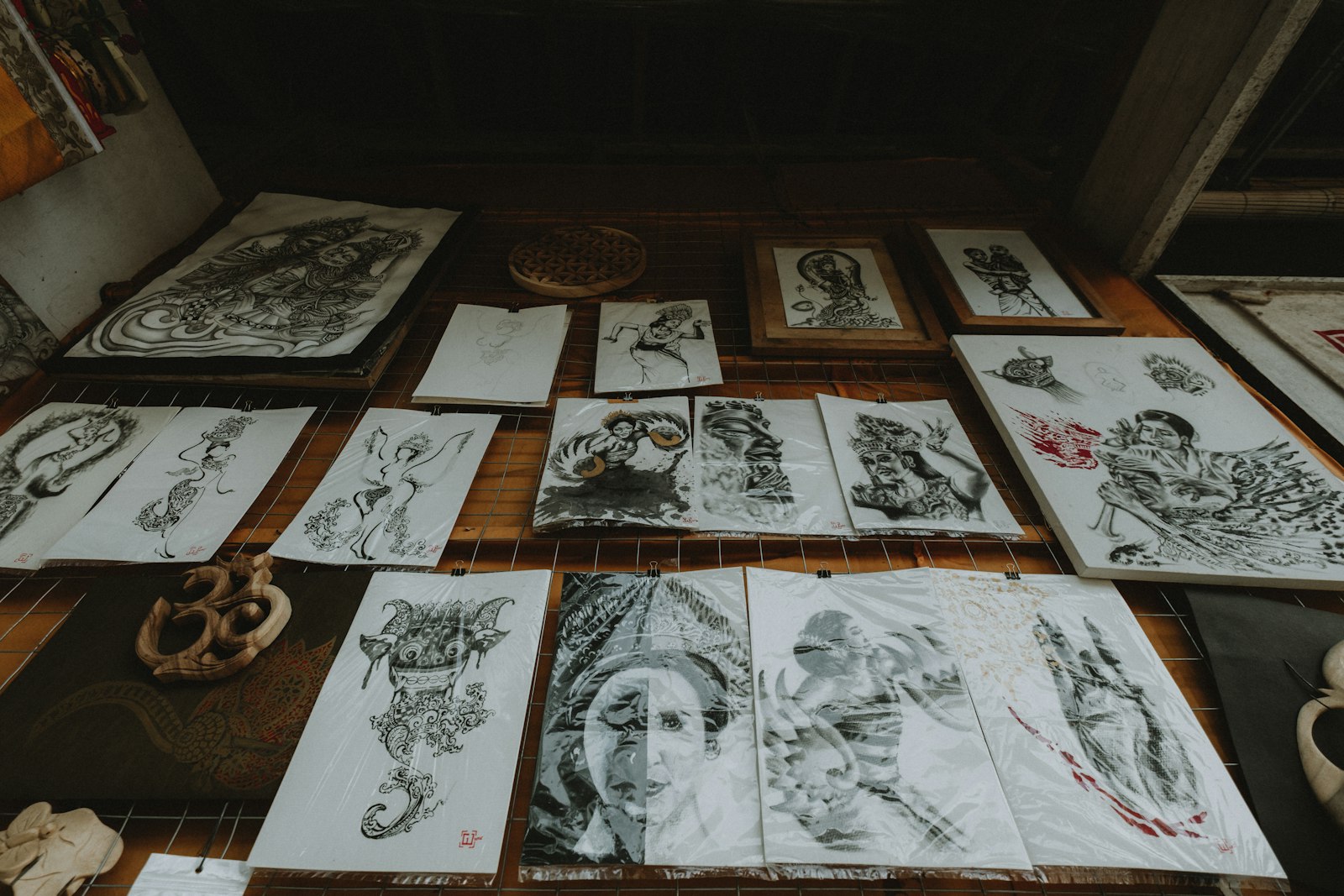 Collection of intricate drawings displayed on a wall.