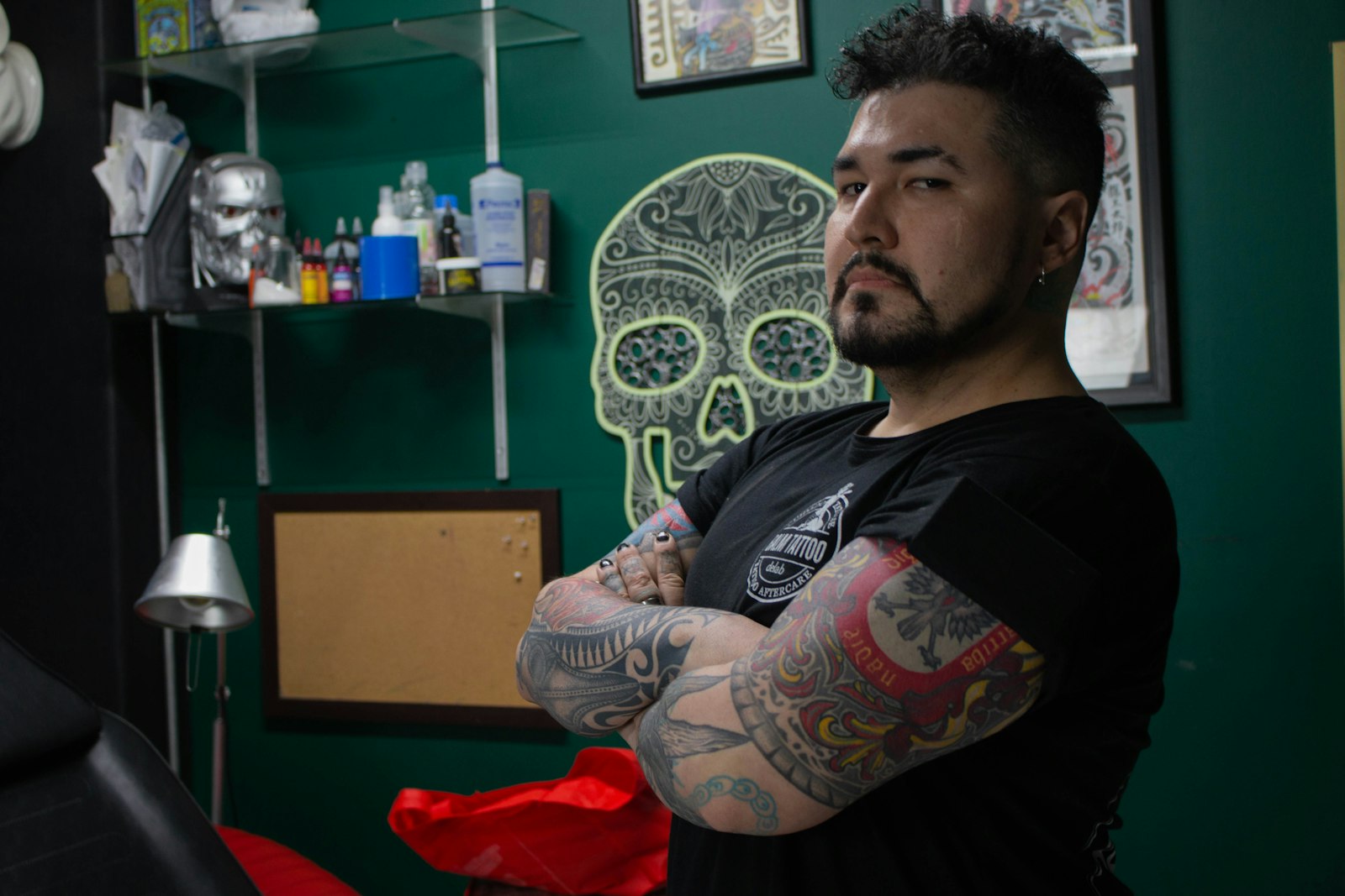a man with tattoos standing in a room