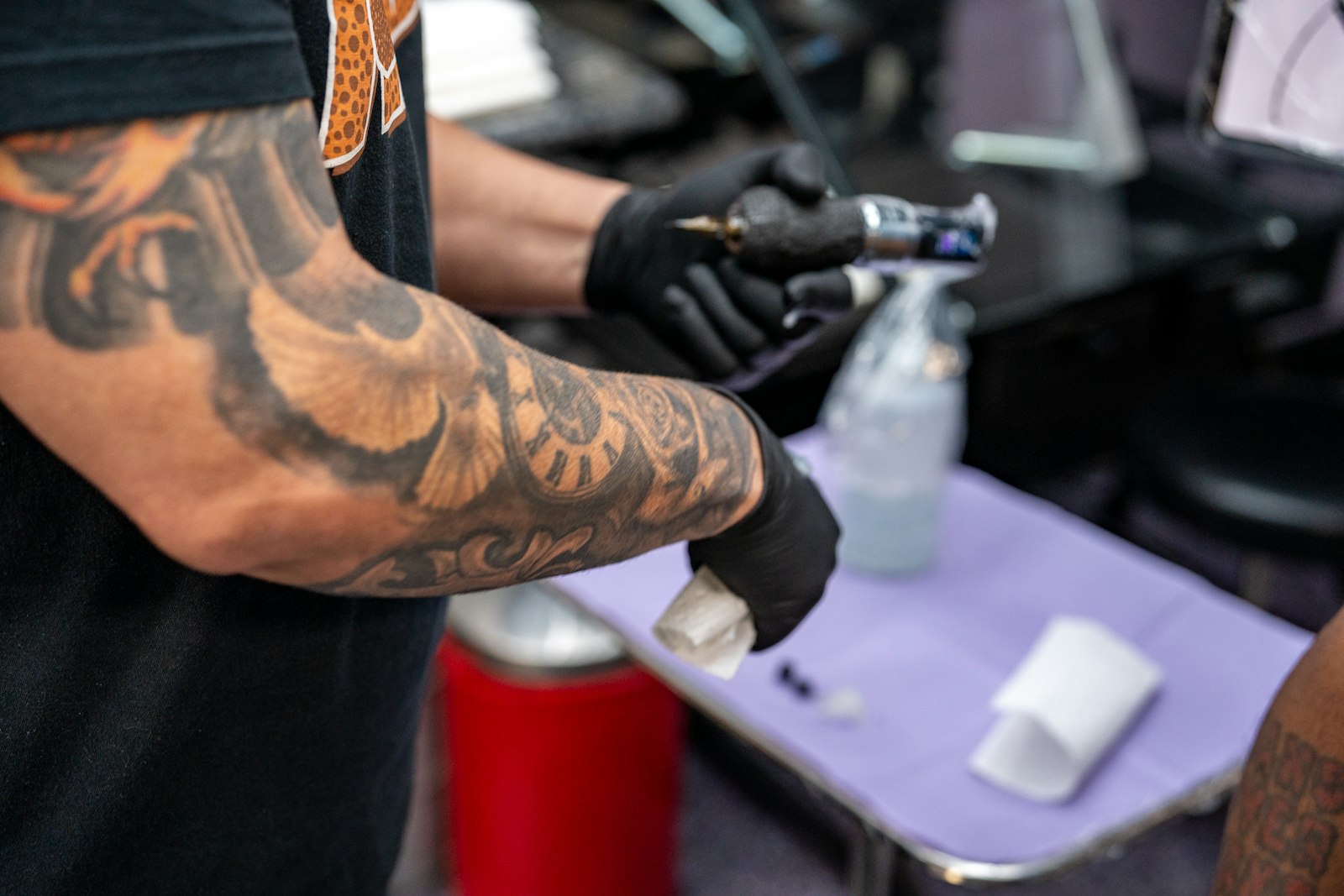 Tattoo artist preparing equipment for new tattoo