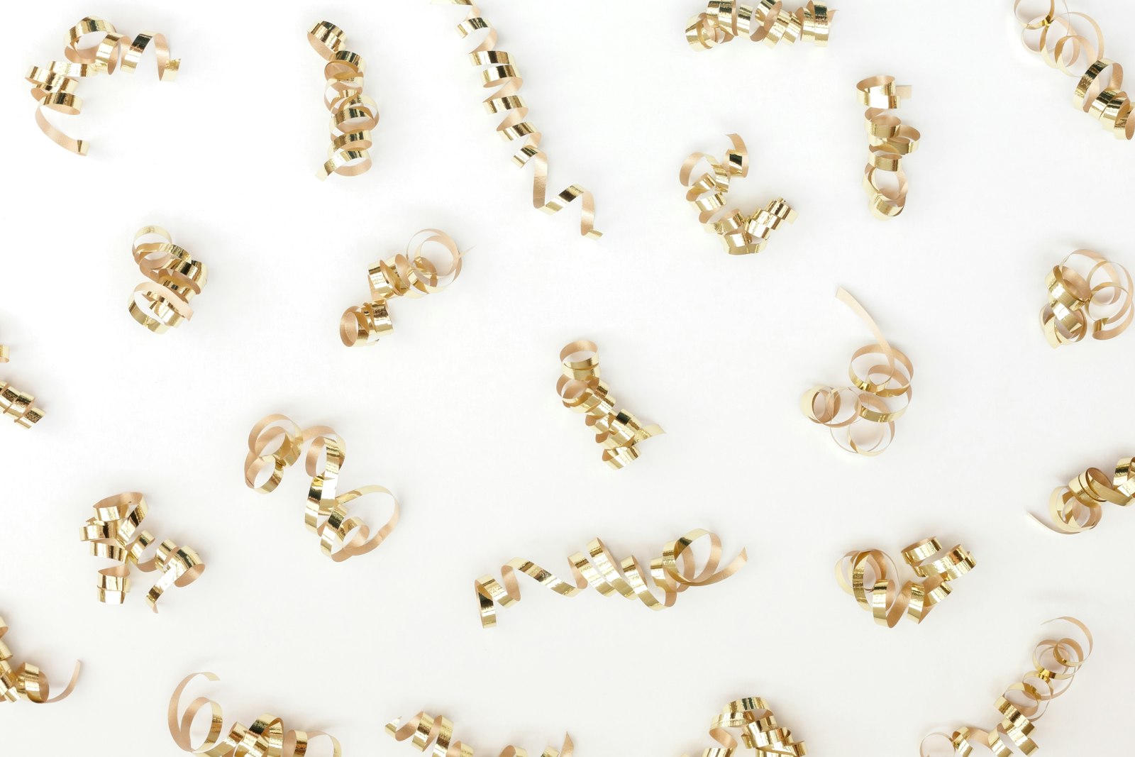 a group of gold colored objects on a white surface